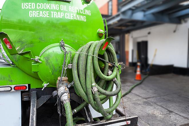 a vacuum truck pumping out a large underground grease trap in Ashland