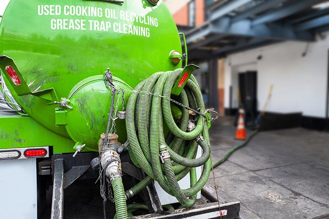 a vacuum truck pumping out a large underground grease trap in Riverside, PA
